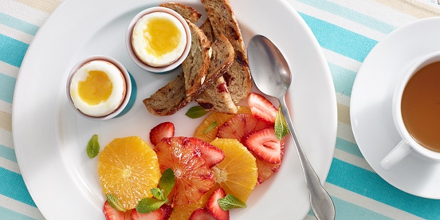 soft boiled eggs with fruit and bread